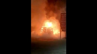 The BMW car in flames on Ferozepur Road in Ludhiana. (HT Photo)