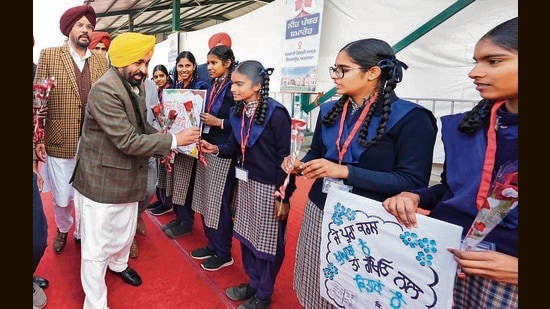 Punjab CM Bhagwant Singh Mann being welcomed by students while laying the foundation stone of a ₹15-crore Government Degree College in Ajnala. (HT Photo)