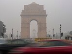 Delhi air pollution Live Updates Vehicles zoom past the India Gate shrouded in fog on a winter morning, in New Delhi. 