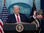 U.S. President Donald Trump holds a poster of an alleged criminal taken off of Minnesota streets by ICE during a press briefing at the White House, on the one-year mark into his second term in office, in Washington, D.C., U.S., January 20, 2026. REUTERS/Jessica Koscielniak