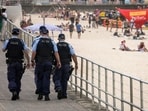 Two men were driving an SUV along the beach in Queensland when they saw around 10 dingoes near the body, police inspector Paul Algie said.