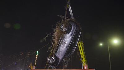 After six hours, the car was eventually fished out of the plot around 6:30 pm. Police said that a sonar system was initially used, but when it failed, a team of NDRF scuba divers manually located the vehicle and pulled it out by placing a chain on the rear hook. (HT Photos) After six hours, the car was eventually fished out of the plot around 6:30 pm. Police said that a sonar system was initially used, but when it failed, a team of NDRF scuba divers manually located the vehicle and pulled it out by placing a chain on the rear hook. (HT Photos)