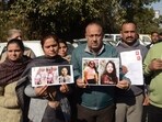 Family members holding photographs of their missing kin during a protest in Jammu on Wednesday. (HT Photo)