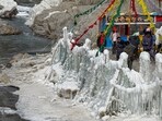 Tourists near frozen Lingti Waterfall at Spiti Valley, in Himachal on Tuesday. (PTI)