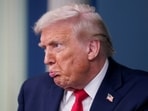 U.S. President Donald Trump reacts during a press briefing at the White House, on the one-year mark into his second term in office, in Washington, DC.