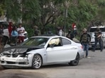 A resident confronts a federal agent near a crashed car as they investigate the scene of a reported shooting in Willowbrook A resident confronts a federal agent near a crashed car as they investigate the scene of a reported shooting in Willowbrook