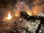 llegally dumped waste in Sector 23A near Tau Devi Lal Park lit on fire as seen on Tuesday. (HT)