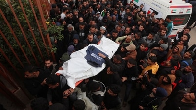 Mourners carry the body of one of the Palestinian journalists killed in an Israeli airstrike on Wednesday, in Khan Younis, in the southern Gaza Strip. (REUTERS)
