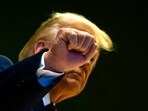 Trump gestures as he climbs a staircase after a signing ceremony of his Board of Peace initiative at the World Economic Forum in Davos.