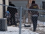 ICE agents stand next Liam Conejo Ramos, a five-year-old detained in Minneapolis, Minnesota, U.S., January 20, 2026.  Rachel James/via REUTERS  THIS PICTURE WAS CROPED BY REUTERS. AN UNCROPED VERSION HAS BEEN PROVIDED SEPARATELY.