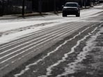 A motorist travels on a road that has been treated with salt brine Thursday, Jan. 22, 2026, in Nashville, Tenn. ahead of a winter storm expected to hit the state over the weekend. 