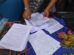 Election Commission officials assist voters at a help desk camp for the Special Intensive Revision (SIR) of electoral rolls. (File photo.)