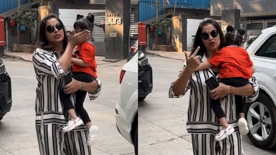 Bipasha Basu hides daughter Devi's face from the paparazzi.