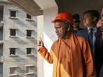 Chief minister Yogi Adityanath inspects ongoing construction work at Major Dhyan Chand Sports University, in Meerut district of Uttar Pradesh on Thursday. (PTI Photo)