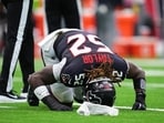Former Houston Texans defensive end Darrell Taylor (52) kneels over on the field after suffering an injury