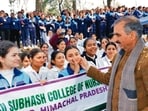 Himachal Pradesh chief minister Sukhvinder Singh Sukhu interacting with students during his visit to the Sulah assembly constituency in Kangra district on Thursday. (HT Photo)
