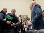 Harry Dunn, former US Capitol Police officer, left, holds back Michael Fanone, retired Metropolitan Police Department (MPD) officer, center, during a confrontation with political operative Ivan Raiklin, right, during a House Judiciary Committee hearing in Washington, DC.