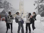 Youngsters playing in the snow after building a snowman at the Ridge in Shimla on Friday morning. (Deepak Sansta/HT)