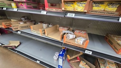 Images from stores show bare aisles where staples like milk, bread, eggs and bottled water are usually stocked. (X) Images from stores show bare aisles where staples like milk, bread, eggs and bottled water are usually stocked. (X)