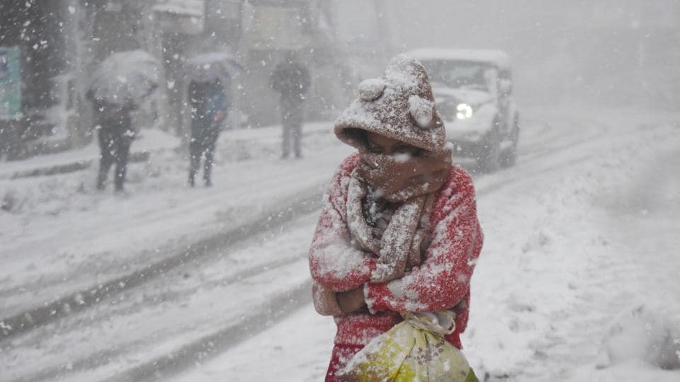 Undeterred, a youngster walking as it snows in Shimla on Friday morning. (Deepak Sansta/HT) Undeterred, a youngster walking as it snows in Shimla on Friday morning. (Deepak Sansta/HT)