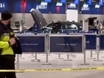 Airport workers and passengers can be seen standing back as emergency responders moved in. 