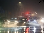 Vehicles commute amid water logging following heavy rainfall, in New Delhi on Friday.