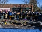 Residents near the scene of a shooting by a federal law enforcement agent in Minneapolis, Minnesota, US, on Sunday, Jan. 25, 2026.