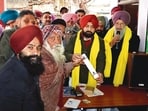 Punjab housing and urban development minister Hardeep Singh Mundian spreads awareness about the scheme in Sahnewal, Ludhiana. (HT)
