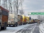 Trucks stranded along the Jammu-Srinagar national highway at Anantnag as NH 44 remained closed for vehicular movement due to snowfall on Saturday. (PTI Photo)