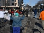 MINNEAPOLIS shooting: Protestors raise their hands while approaching federal agents amid protests following a shooting on January 24, 2026 in Minneapolis, Minnesota. 