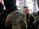 FILE PHOTO: Border Patrol commander Greg Bovino looks on during a stop at a gas station, as immigration enforcement continues after a U.S. Immigration and Customs Enforcement (ICE) agent fatally shot Renee Nicole Good on January 7, in Minneapolis, Minnesota, U.S., January 21, 2026. REUTERS/Seth Herald/File Photo