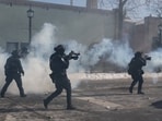 Minneapolis Police Department officers amid tear gas during clashes with community members at the scene where federal agents fatally shot a man while trying to detain him, in Minneapolis, Minnesota, U.S., January 24, 2026.