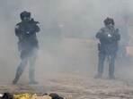 Minneapolis Police Department officers amid tear gas during clashes with community members at the scene where federal agents fatally shot a man while trying to detain him, in Minneapolis, Minnesota, U.S., January 24, 2026.