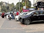 Vehicles parked on a footpath on Malhar Road in Ludhiana on Saturday. (Manish/HT)