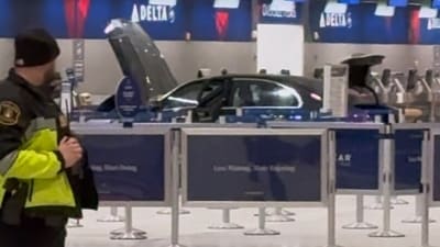 Caution tape ropes off a scene after a car crashed through the entrance of the Detroit Metropolitan Wayne County Airport on Friday. (AP)