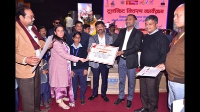 Minister Nand Gopal Gupta ‘Nandi’ speaking at the ‘Viksit Uttar Pradesh – Viksit Bharat’ programme organised in the Magh Mela area on Saturday. (HT )