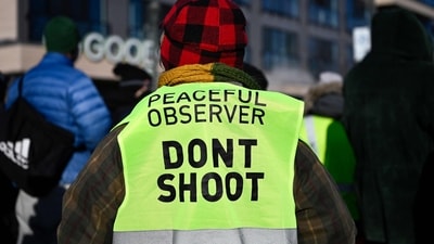 A person with an observer vests joins onlookers after federal agents allegedly shot a protestor amid a scuffle to arrest him on January 24, 2026 in Minneapolis, Minnesota. The Trump administration has sent a reported 3,000 federal agents into the area, with more on the way, as they make a push to arrest undocumented immigrants in the region. Stephen Maturen/Getty Images/AFP (Photo by Stephen Maturen / GETTY IMAGES NORTH AMERICA / Getty Images via AFP) (Getty Images via AFP) A person with an observer vests joins onlookers after federal agents allegedly shot a protestor amid a scuffle to arrest him on January 24, 2026 in Minneapolis, Minnesota. The Trump administration has sent a reported 3,000 federal agents into the area, with more on the way, as they make a push to arrest undocumented immigrants in the region. Stephen Maturen/Getty Images/AFP (Photo by Stephen Maturen / GETTY IMAGES NORTH AMERICA / Getty Images via AFP) (Getty Images via AFP)