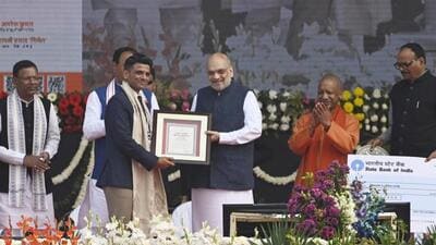 Union home minister Amit Shah awarding Shubhanshu Shukla as chief minister Yogi Adityanath looks on, during UP Diwas celebrations in Lucknow on Saturday. (HT) Union home minister Amit Shah awarding Shubhanshu Shukla as chief minister Yogi Adityanath looks on, during UP Diwas celebrations in Lucknow on Saturday. (HT)