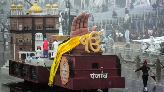 Gram it: The drenched Friday that Delhi saw was nothing short of extraordinary as tableaux representing different states rolled down Kartavya Path during the full dress rehearsals for upcoming Republic Day celebrations. Here's a glimpse of the aesthetically designed Punjab tableau that will apparently showcase a replica of the popular Golden Temple situated in Amritsar. (Photo: Rahul Singh/ANI)