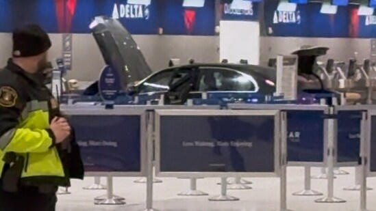Caution tape ropes off a scene after a car crashed through the entrance of the Detroit Metropolitan Wayne County Airport on Friday. (AP)