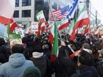 Iran-US tensions highlights: Protestors hold Lion and Sun flags, a US and an Israeli flag as they take part in a demonstration held by members of the Iranian diaspora in solidarity with the protests
