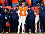 Denver Broncos quarterback Jarrett Stidham (8) stands next to quarterback Bo Nix (10) during overtime of an AFC Divisional Round playoff game against the Buffalo Bills at Empower Field at Mile High.