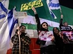 Israelis hold signs and flags, as they rally against the government of Iran, in Holon, Israel, January 24, 2026. 