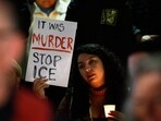 A demonstrator holds a sign during a candlelight vigil during a protest in response to the fatal shooting of 37-year-old Alex Pretti in Minneapolis earlier in the day Saturday, Jan. 24, 2026, in Los Angeles. (AP Photo/Caroline Brehman)