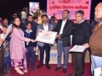 Minister Nand Gopal Gupta ‘Nandi’ speaking at the ‘Viksit Uttar Pradesh – Viksit Bharat’ programme organised in the Magh Mela area on Saturday. (HT )