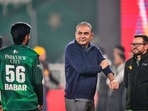 Chairman of Pakistan Cricket Board Mohsin Naqvi, centre, chats with Pakistan's Babar Azam, left, as head coach Mike Hesson watches. 