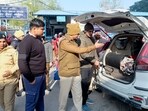 Security personnel check a vehicle amid high alert ahead of Republic Day celebrations in Gurugram on Sunday. (PTI) Security personnel check a vehicle amid high alert ahead of Republic Day celebrations in Gurugram on Sunday. (PTI)