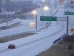 Vehicles move on snow-covered Highway 67 during a winter storm Saturday, Jan. 24, 2026, in Dallas. (AP Photo/Julio Cortez)