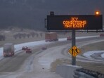 Vehicles travel eastbound on Interstate-20 near a sign advising motorists of possible icy conditions during a winter storm Saturday, Jan. 24, 2026, in Dallas. (AP Photo/Julio Cortez)