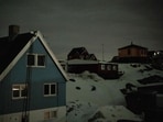 Clad in snow, houses in downtown Nuuk stood amid pitch darkness after strong winds caused a vast power outage across the Greenlandic capital on Saturday.(Mads Claus Rasmussen/AFP)